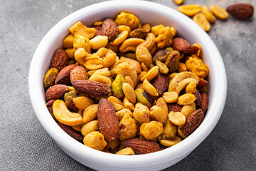 nut salt snack mix almond, cashew, pistachio, peanut fresh nuts food on the table copy space food background rustic top view