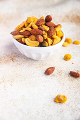 nut salt snack mix almond, cashew, pistachio, peanut fresh nuts food on the table copy space food background rustic top view