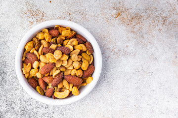 nut salt snack mix almond, cashew, pistachio, peanut fresh nuts food on the table copy space food background rustic top view