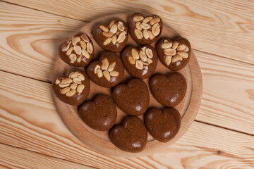 Homemade caramel. Brown caramel candies. Creamy sweets with peanuts. On pine boards.