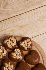 Homemade caramel. Brown caramel candies. Creamy sweets with peanuts. On pine boards.