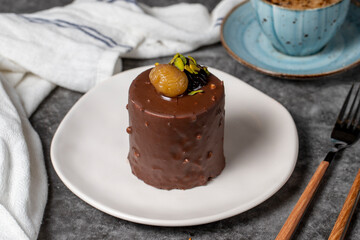 Chocolate and chestnut cake on a dark background. Delicious cake with cream filling. Studio shoot. Bakery products. close up