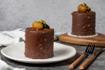 Chocolate and chestnut cake on a dark background. Delicious cake with cream filling. Studio shoot. Bakery products. close up