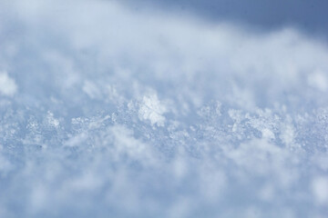 Obraz premium natural snowflakes on snow, photo of real snowflakes. Winter snow background. Snowflake close-up. Macro photo. Copy space.