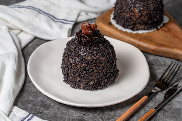 Chocolate and pistachio cake on a dark background. Delicious cake with cream filling. Studio shoot. Bakery products. close up