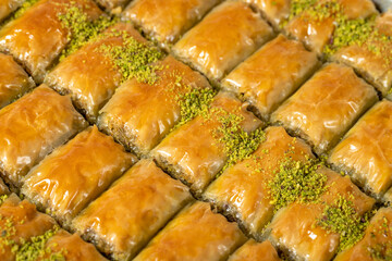 Baklava with pistachio on a dark background. Traditional Turkish baklava. Studio shoot. close up