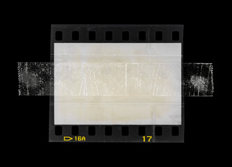 blank 35mm diafilm frame fixed by sticker adhesive tape on black background.