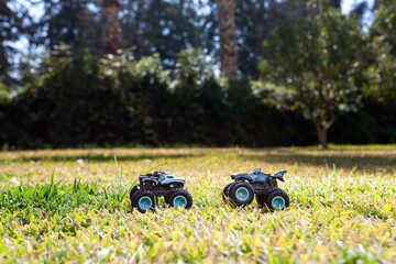 Boy is playing a cars multitrack on the garden 