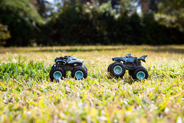 Boy is playing a cars multitrack on the garden 