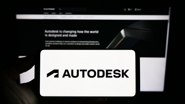 Stuttgart, Germany - 12-30-2022: Person holding cellphone with logo of US software company Autodesk Inc. on screen in front of business webpage. Focus on phone display.
