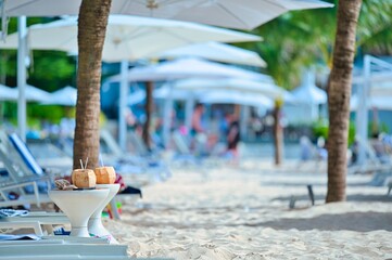 White sand beach and blue sea landscape view of a tropical resort hotel beside modern swimming...