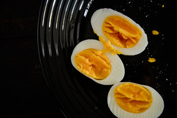 boiled eggs on a black plate
