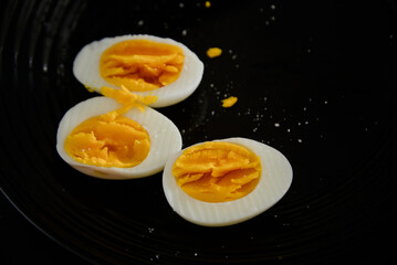 boiled eggs on a black plate
