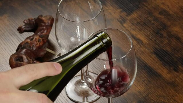 personne qui sert un verre de vin 