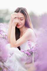 asian woman wearing white dress in the flowers garden. travel relax on vacation concept..
