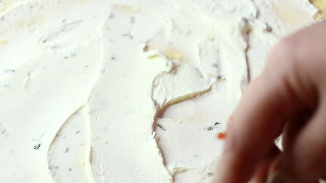 flatbread is spread with cottage cheese with a spoon