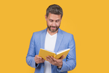 photo of businessman reading planner. businessman reading planner isolated on yellow