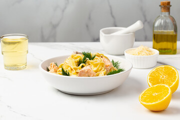 Pasta with salmon on a white background