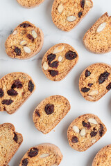 Biscotti cantucci cookies with almond and cranberry on white background top view