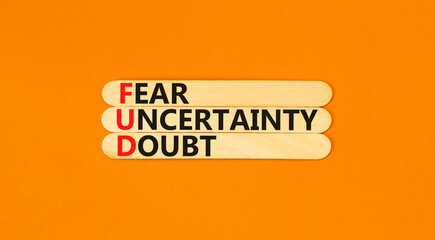 FUD fear uncertainty doubt symbol. Concept words FUD fear uncertainty doubt on wooden sticks on a...