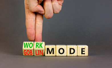 Work or goblin mode symbol. Concept word Work mode Goblin mode on wooden cubes. Businessman hand....