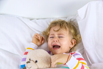 Children are crying in bed. Selective focus.