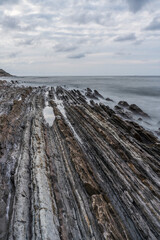 Sunset at the Flysch geological coastline, with Flysch formations in Zumaya in the Basque Country, Spain