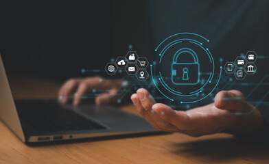 Men hand holding lock icon while using computer laptop with internet connection. Sign of cybersecurity protection to prevent from virus, cyber crime and digital threat to privacy and information.