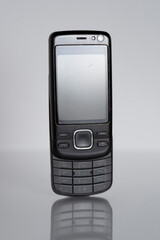 Retro black mobile cell phone with sliding keyboard isolated