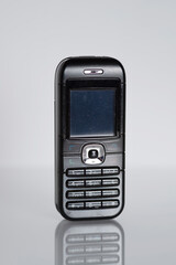 Retro black mobile cell phone 1990s isolated