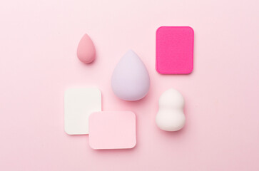 Beauty blenders on color background, top view