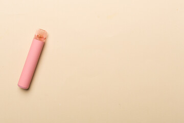 Disposable electronic cigarette on color background, top view