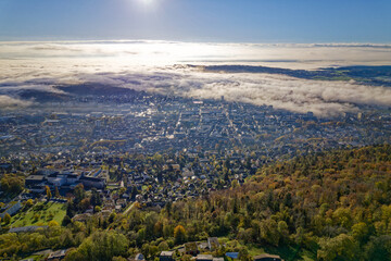 Aerial view over Swiss City of Biel Bienne, Canton Bern, seen from village Evilard on a sunny foggy autumn morning. Photo taken November 10th, 2022, Evilard, Switzerland. - obrazy, fototapety, plakaty