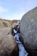 View on a waterfall in the Grimsel Pass which is a mountain pass in Switzerland, crossing the...