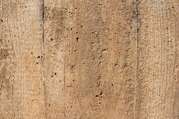 Old gray brown irregular concrete wall as background