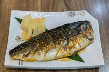 Grilled Saba on grill with slice ginger. Fried Mackerel steak. Japanese Mackerel Grilled (Saba Shio Yaki). Saba in teriyaki sauce popular japanese cuisine
