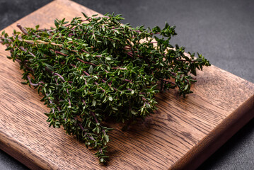 Bunch of fresh picked thyme on a dark concrete background