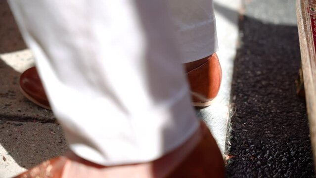 Indian wedding ritual. A foot of indian groom crush on a ritual object