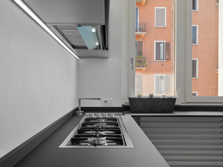 Close-up of gas hob and steel sink in the modern kitchen