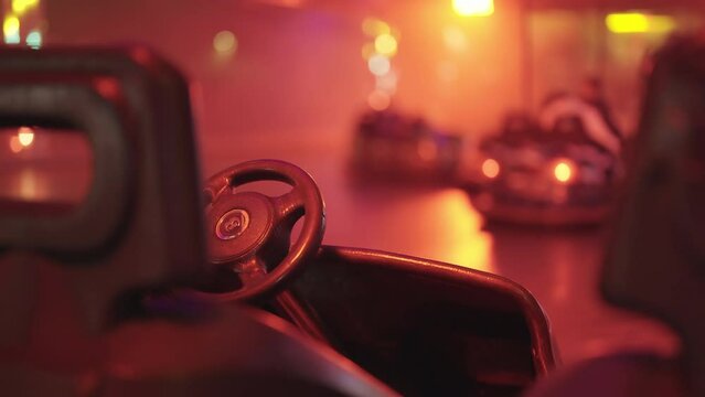 Bumper cars in amusement park people having fun driving 4K