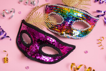 Festive face masks for carnival celebration on colored background. Carnival concept