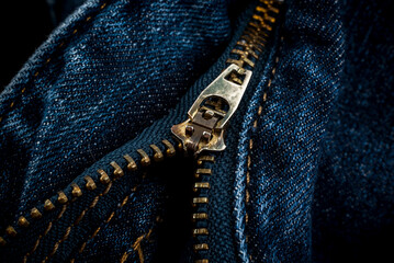 Closeup of zipper in blue jeans. Zipper with lock. A piece of denim