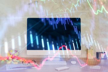 Forex graph hologram on table with computer background. Double exposure. Concept of financial markets.