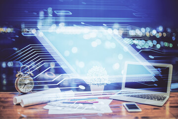 Double exposure of table with computer on background and data theme hologram. Data technology concept.
