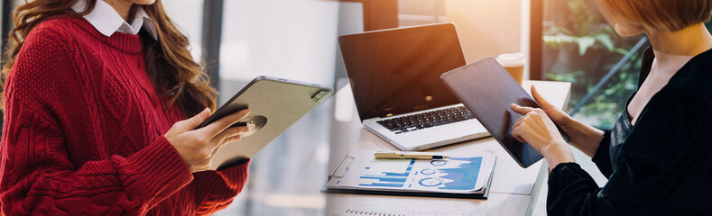 Businessman and team analyzing financial statement Finance task. with smart phone and laptop and...