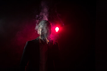 Photo of smoking man on pink background.