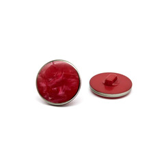 Collage of two sewing buttons isolated on a white background, back view and front view. Red sewing button on a white background. Button on the leg