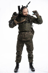 Fototapeta premium soldier in the studio on a white background. a man in military uniform with a rifle or machine gun. military or airball player