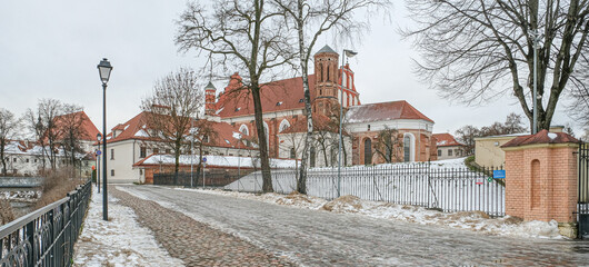 Fototapeta na wymiar Gothic Church of St. Anne and Church of St. Francis and St. Bernardine ensemble in winter as seen from the back in the Old Town of Vilnius, Lithuania