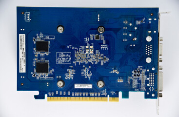 Electronic graphics card board with chips and radio elements. The reverse side of the video card....